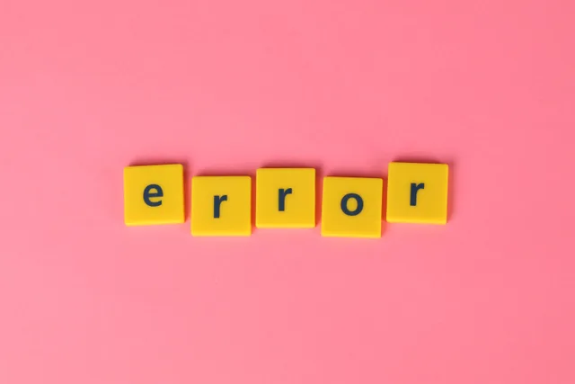 Yellow block letters spelling 'error' on a vibrant pink background, capturing a playful message. B2B marketing analytics mistakes when ranking channels