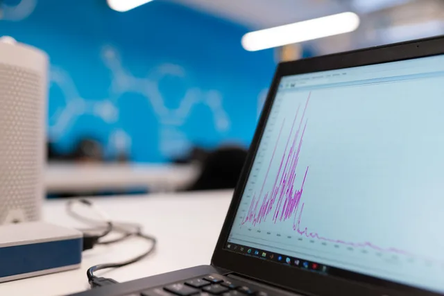Laptop displaying data analytics graph in a modern office setting, symbolizing growth and technology. Which B2B marketing analytics tools to shortlist