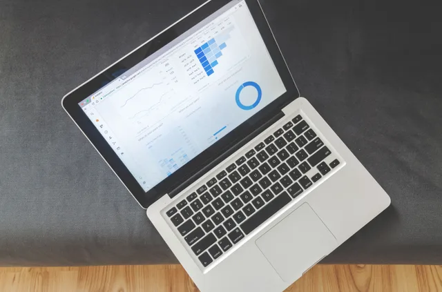 Overhead view of a laptop showing data visualizations and charts on its screen. A framework for common B2B marketing analytics questions